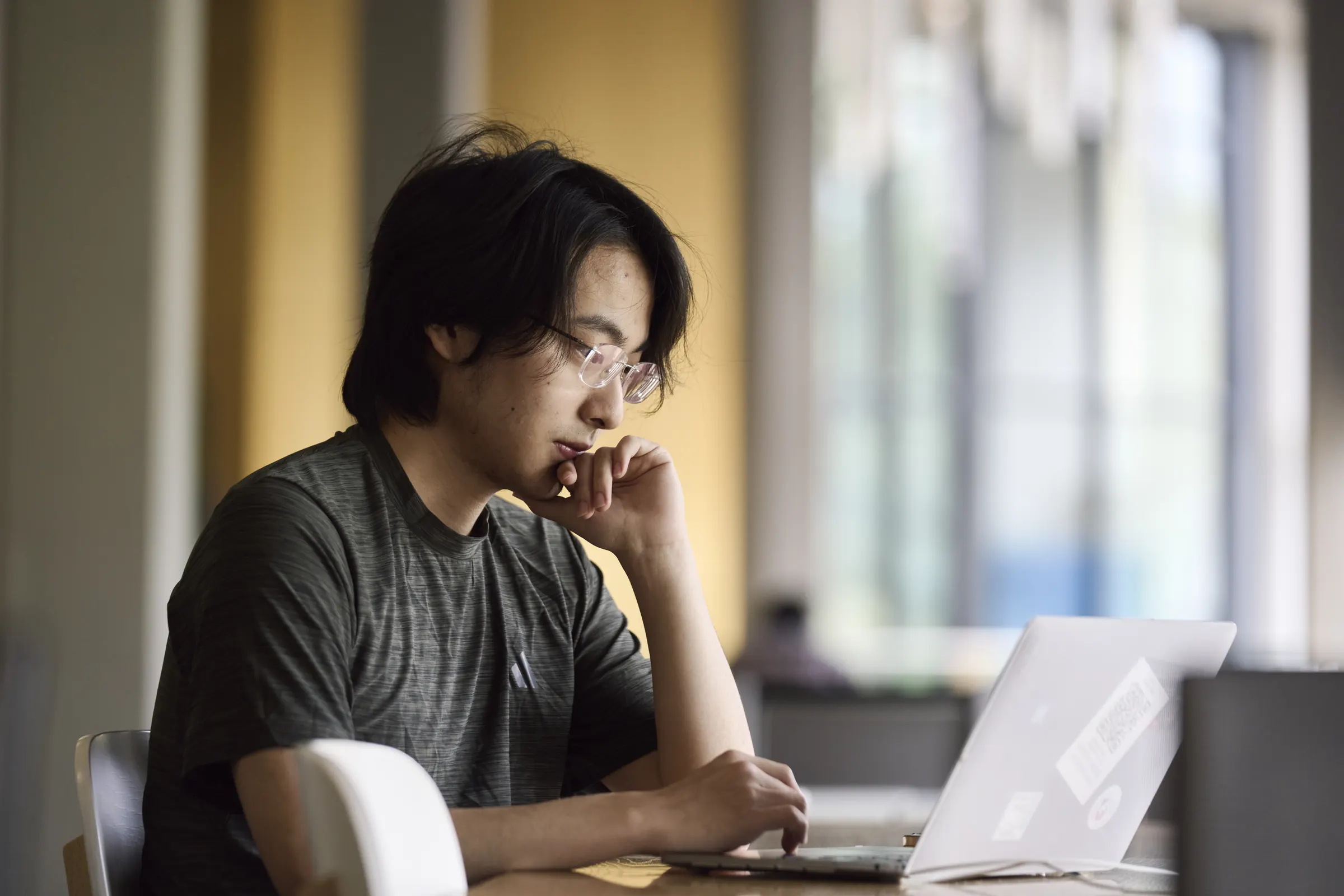 A student studying at a laptop